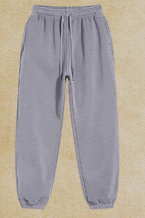 Gray relaxed fit drawstring sweatpants with cuffed ankles and side pockets.