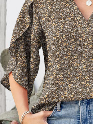 Floral v-neck blouse with flutter sleeves and a brown floral print.