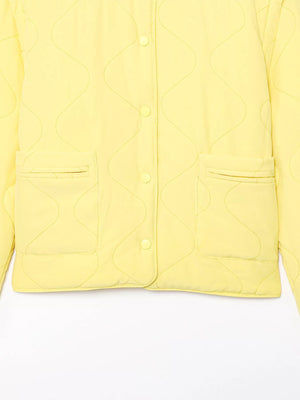 Yellow quilted snap puffer jacket with wave stitching and patch pockets.