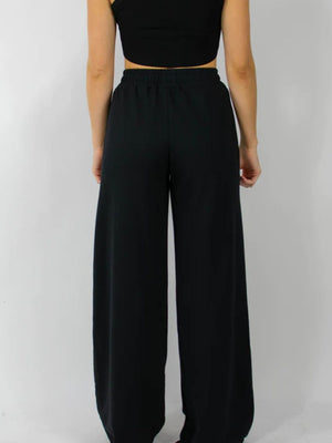 Black wide-leg lounge pants with an elastic waistband.