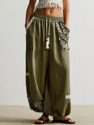Moss drawstring harem pants with lace trim details and tassel drawstring.