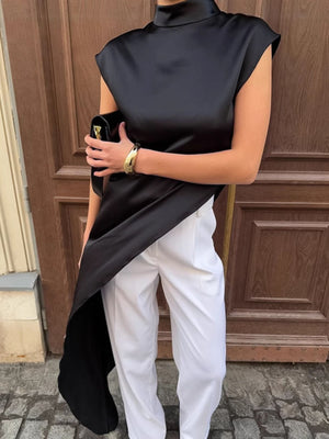 Black cap sleeve turtleneck blouse with asymmetrical hem and high neck.