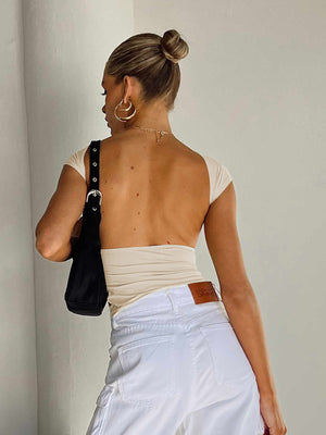 Cream backless cap sleeve crop top with a low back detail.
