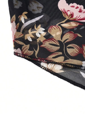 Sheer black blouse with vibrant floral print, round neck, and draped detail.