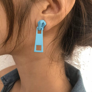 Blue zipper drop earrings with a square cutout detail.