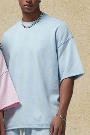 Light blue boxy t-shirt with raw edge hem and sleeves, crew neck.