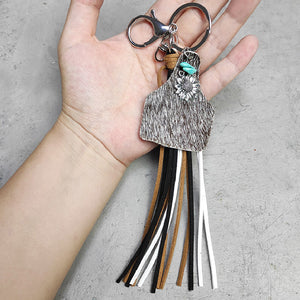 Leopard print tag keychain with silver sunflower charm, turquoise accent, and multi-color tassels.