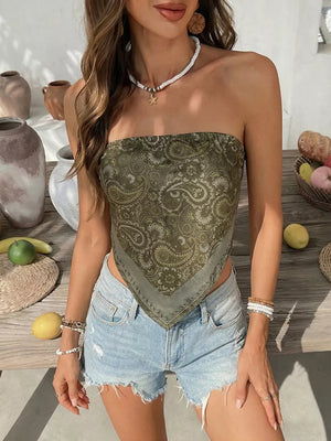 Green paisley print bandeau top with a handkerchief hem, styled with denim shorts.