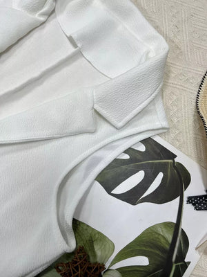 White longline vest coat with textured fabric and notch collar.
