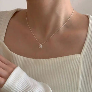 Sterling silver dainty necklace with a heart lock and key charm.