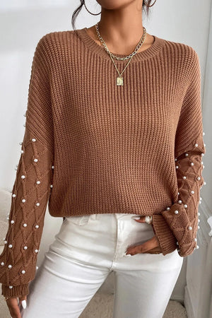 Brown cable knit sweater with pearl embellished sleeves and crew neck.