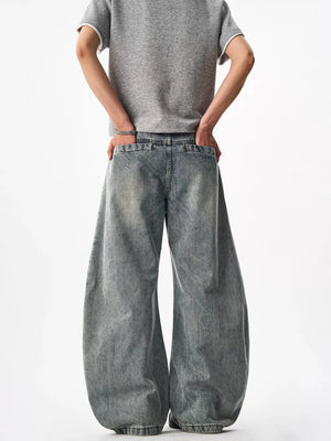Belted wide-leg blue denim jeans with a baggy fit and cotton material.