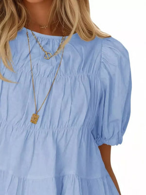 Sky blue maternity blouse with puff sleeves, ruffled tiers, and smocked bodice detail.