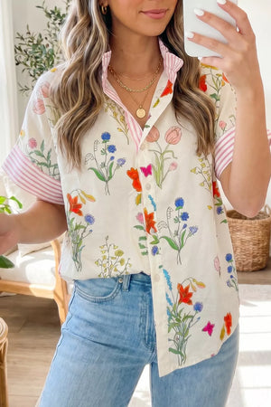 Charming floral print button-down shirt with ruffled collar and pink striped sleeves.
