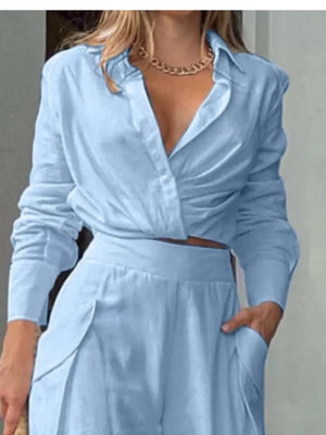 Light blue polyester two-piece set with pocketed pants and a ruched, collared shirt.