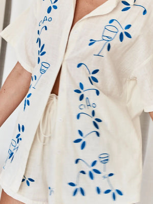 Cream linen co-ord set with blue floral embroidery and "Ciao" text.