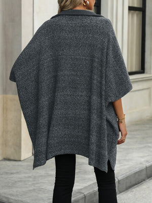 Dark gray knit asymmetrical zip-neck poncho with a textured marled pattern and a relaxed fit.