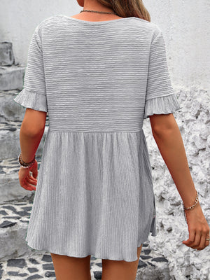 Light Gray textured babydoll blouse with flutter sleeves and smocked waist detail.