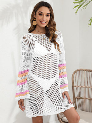 White crochet cover up dress with bell sleeves and striped cuffs, worn over a bikini