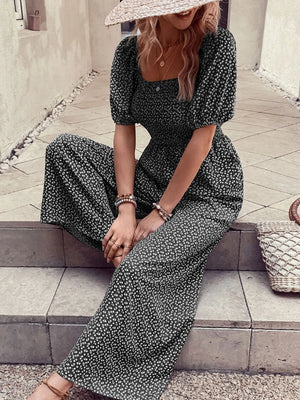 Smocked bodice floral wide-leg jumpsuit in black with puff sleeves and square neckline.