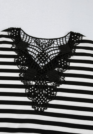 Black and white striped blouse with ornate black lace neckline detail.