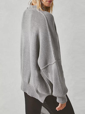 Oversized dark gray ribbed knit sweater with drop shoulders and a relaxed fit.
