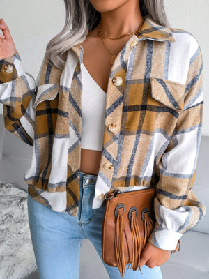 Oversized plaid shacket in camel with patch pockets and button front, worn open over a white crop top.