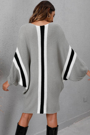 Light gray oversized knit cocoon dress with black and white stripes, batwing sleeves.