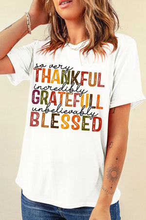 White cotton crewneck tee with colorful "Thankful, Grateful, Blessed" typography graphic.