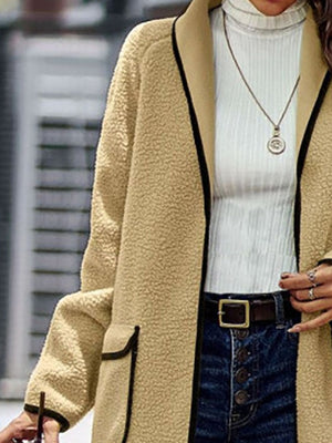 Camel teddy coat with black contrast trim and pockets.