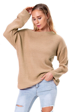 Tan waffle knit off-shoulder sweater with long sleeves and a relaxed fit.