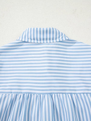 Blue and white striped button-down shirt with a collar and shirred hem detail.