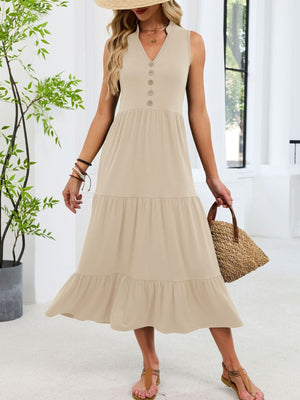 Apricot tiered midi dress with notched V-neck and decorative buttons.