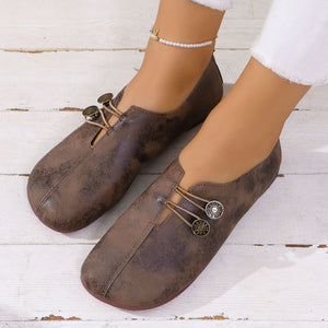 Dark brown round-toe casual flats with decorative buttons and elastic detail