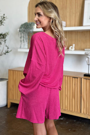 Waffle knit lounge set in hot pink with blouson sleeves and shorts.