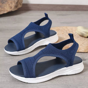 Dark blue knit open-toe platform sandals with white soles.
