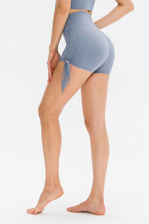 Light blue ruched-side active shorts with drawstrings and high waist.