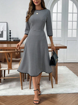 Black and white gingham midi dress with 3/4 sleeves, A-line cut, and crew neck.