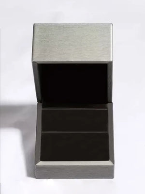 Silver ring box with textured lid and dark interior