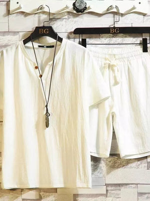White cotton two-piece set with drawstring shorts and henley neckline shirt.