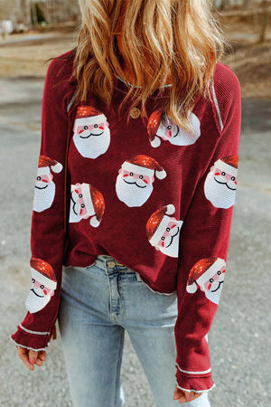 Scarlet waffle knit top with sequin Santa faces, crew neck, long sleeves, and ruffled cuffs.