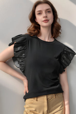 Black blouse with ruffled faux leather sleeves and ribbed texture.