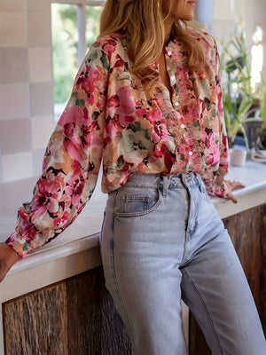 Frill trim button-up shirt with a vibrant floral print and long sleeves.
