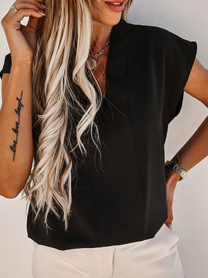 Black V-neck blouse with short sleeves and vertical seams.
