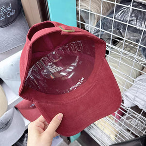 Red baseball cap with embroidered detail on inner band and adjustable strap.