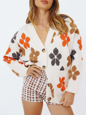 White knit cardigan with floral appliqué, V-neck, button-front, and pockets.
