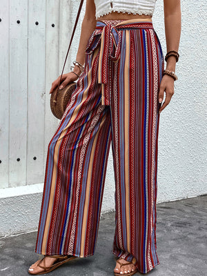 Bohemian stripe palazzo trousers in rust with a tie-waist and wide leg.