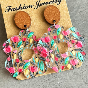Floral acrylic bloom earrings with wood tops and pink floral pattern.