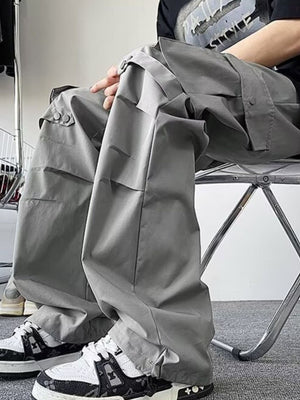Light gray wide-leg cargo pants with multiple pockets and button details.