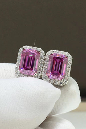 Emerald cut moissanite halo stud earrings in rose gold with diamond accents.